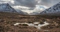 Majestic dramatic Winter sunset sunbeams over landscape of Lost Valley in Etive Mor in Scottish Highlands Royalty Free Stock Photo