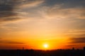 Majestic dusk in tropics. Golden sunset sky with beautiful silhouette city buildings in the evening. Warm colors