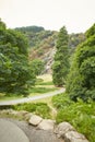 Majestic forest round water cascade of Powerscourt Waterfall, the highest waterfall in Ireland. Famous tourist attractions in co. Royalty Free Stock Photo