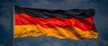 Majestic German Flag Waves Against Blue Sky - Symbol of Unity & Pride. Concept German Flag,