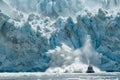 Majestic glacier calving with boat witnessing the dramatic event