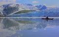 Majestic glacier and kayaker reflection in alaska