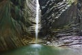 Majestic grotto with pouring beautiful waterfall Royalty Free Stock Photo