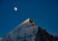 Majestic himalayan mountain Mt. bhagirathi sisters in moonlight in the evening. peak is lit by last light of sunset