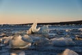 Majestic iceberg, partially submerged in the shallow waters of a beach