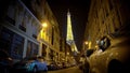 Majestic illuminated Eiffel Tower sparkling at night, view from narrow street