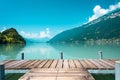 Majestic lake with clear turquoise water. Wooden pier. Brienz lake in the village of Iseltwald, Switzerland. Royalty Free Stock Photo