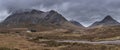 Majestic landscape image view down Glencoe Valley in Scottish Highlands with mountain ranges in dramatic Winter lighting Royalty Free Stock Photo