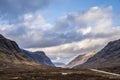 Majestic landscape image view down Glencoe Valley in Scottish Highlands with mountain ranges in dramatic Winter lighting Royalty Free Stock Photo