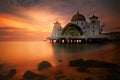 Majestic landscape shot of the white floating Mosque near the beach in Melacca, Malaysia