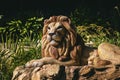 Majestic lion statue standing on a grassy field. Royalty Free Stock Photo