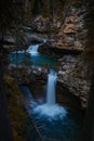 Majestic long exposure shot of the rocky waterfall cascading down the hill