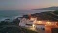 Majestic marine twilight drone view. High red lighthouse standing at sea coast Royalty Free Stock Photo