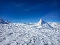 Majestic Matterhorn mountain in front of a blue sky with snow in