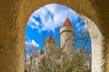 Majestic medieval castle view through stone arch on a clear day Royalty Free Stock Photo