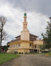 MAJESTIC MOSQUE WITH MINARETS SOARING UP INTO THE OVERCAST SKY