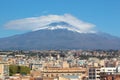 Majestic Mount Etna volcano with Italian city Catania at the foot of the mountain. Snow on the very top of the volcano Royalty Free Stock Photo