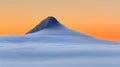 Majestic mountain enveloped in fog at sunrise with orange sky stunning morning landscape