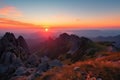 majestic mountain landscape with sunrise, pink and orange sky visible above the horizon