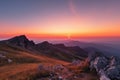 majestic mountain landscape with sunrise, pink and orange sky visible above the horizon