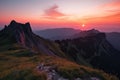 majestic mountain landscape with sunrise, pink and orange sky visible above the horizon