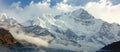 Majestic Mountain Painting: Snowy Peaks Embraced by Clouds