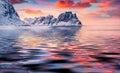 Majestic mountain peak reflected in the calm waters of Norwegian sea. Royalty Free Stock Photo