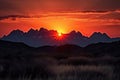 majestic mountain range, with fiery sunset in the background and silhouettes of peaks Royalty Free Stock Photo