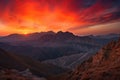 majestic mountain range with fiery sunsets illuminating the canyons