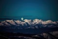 majestic mountain range with a full moon shining over the peaks Royalty Free Stock Photo