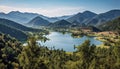 Majestic mountain range reflects tranquil autumn meadow in aerial view generated by AI Royalty Free Stock Photo