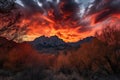 majestic mountain range surrounded by fiery sunsets, with clouds and trees in the foreground