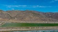 Majestic mountain ranges along the coast with lush green farmland and freeways with cars and blue sky with clouds at Rincon Beach Royalty Free Stock Photo