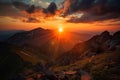 majestic mountain sunset, with the sun setting behind the peaks and clouds Royalty Free Stock Photo