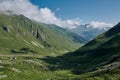 Majestic mountain valley summer landscape with green hills, river and white clouds Royalty Free Stock Photo