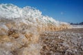 an ocean wave with foaming white on top of a sandy beach Royalty Free Stock Photo