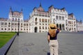 Majestic palace of Hungarian Parliament in Budapest, Hungary. Young tourist woman discovering beauty landmarks of Europe Royalty Free Stock Photo