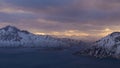 Panorama of afternoon sun shining through clouds with visible sunbeams over the fjords near Rekvik, Troms og Finnmark, Norway. Royalty Free Stock Photo