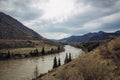 Majestic panorama of the Altai Mountains on spring or autumn day. Rocky mountains and the bend of Katun River under a cloudy sky Royalty Free Stock Photo