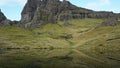 Majestic rock formation in Old Man of Storr, Isle of Skye, United Kingdom and reflection in small lochan.