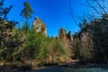 Majestic rock formations amidst forest path under clear blue sky Royalty Free Stock Photo