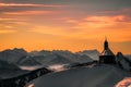 Majestic scene of a traditional alpine church surrounded by snow-covered mountains in Austria Royalty Free Stock Photo