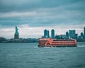 Majestic ship sailing through the tranquil blue waters framed by the iconic Statue of Liberty