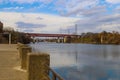 A majestic shot of the Cumberland river with a red bridge over the water and gorgeous autumn colored trees on the banks Royalty Free Stock Photo