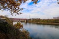 A majestic shot of the Cumberland river with a red bridge over the water and gorgeous autumn colored trees on the banks Royalty Free Stock Photo