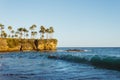 Majestic shot of Laguna beach with perfect surfing waves and tropical trees along a coastline, CA