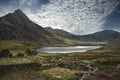 Epic image of sky over landscape of Tryfan and Llyn Ogwen in Snowdonia Wales Royalty Free Stock Photo