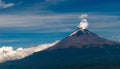 Majestic slumber: A serene yet potent volcano breathes against the backdrop of a tranquil sky