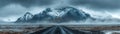 Majestic Snow Capped Mountain Range with Dramatic Cloudscape and Deserted Road Leading Towards the Frontier, Captured in a Royalty Free Stock Photo