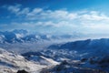 majestic snow-capped mountain range stretching to the horizon, with a view of an ethereal blue sky